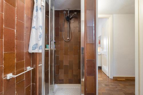 a shower with a glass door in a bathroom at Villetta Pineta in Santa Margherita di Pula