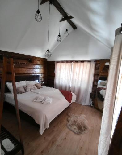 a bedroom with a bed with two towels on it at Casa33 in Dobrovnik