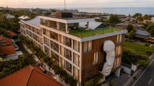 an aerial view of a building with a large building at Sunny Muse by Betterplace in Canggu