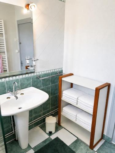 a bathroom with a sink and a mirror and towels at chambres nature in La Celle-sous-Gouzon
