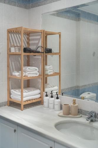 a bathroom counter with a sink and a mirror at Riviera by Urban Luxy in Athens