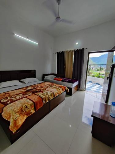a hotel room with two beds and a balcony at Hotel Riversight in Uttarkāshi