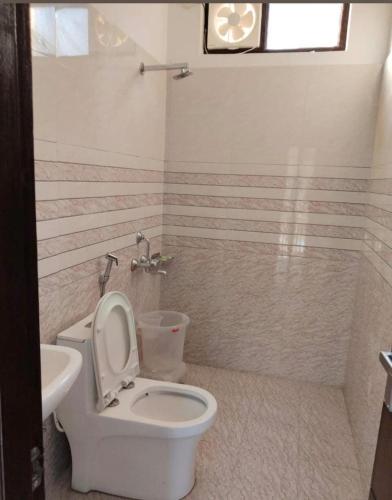a bathroom with a toilet and a sink at Hotel Riversight in Uttarkāshi