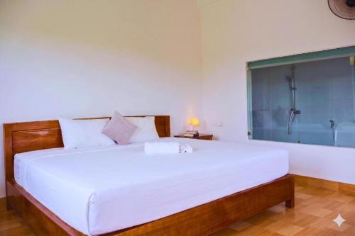 a bedroom with a large bed and a shower at Tam coc Sylvani Homestay in Vũ Lâm