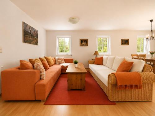 a living room with two couches and a red rug at Chalet am Berg Turracher Höhe Natur & Ski in Turracher Hohe