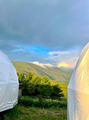 a white tent with a view of a field at Lakeside glamping in Tsovagyugh