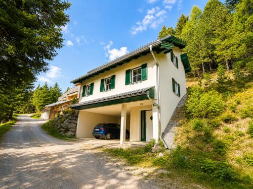 a house with a car parked on the side of a road at Chalet am Berg Turracher Höhe Natur & Ski in Turracher Hohe