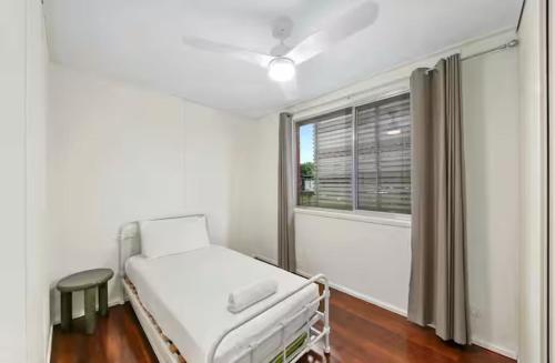 a hospital bed in a room with a window at Beach Side on Burke - Pet Friendly in Golden Beach