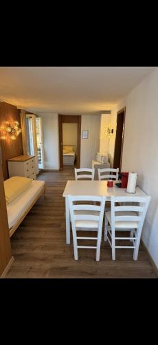 a room with a table and chairs and a bed at Apartment MICKEY in Interlaken