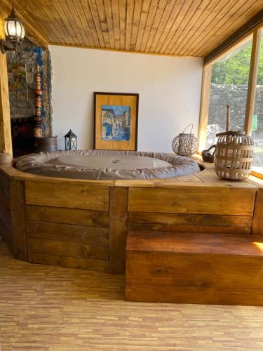 a large wooden bed in a room with a window at Vila Agroturizam Kućica Mostar in Mostar