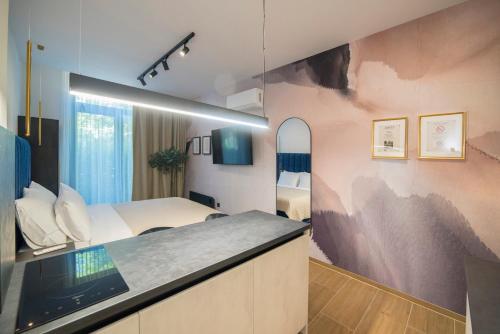 a hotel room with a bed and a mirror at Loco Studio Apartments - Private Entrance & Self Check-in in Zagreb