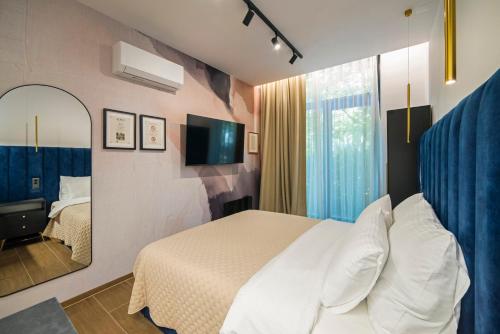 a hotel room with a bed and a mirror at Loco Studio Apartments - Private Entrance & Self Check-in in Zagreb