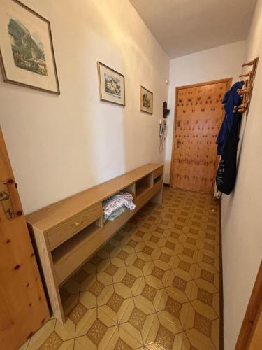a room with a wooden bench and a door at Vecchio Mulino-Ceci's Flat in Entracque