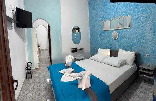 a bedroom with a bed with a stuffed animal on it at Pelagos Beachfront in Panormos Skopelos