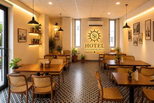 a restaurant with tables and chairs and a sign that reads hotel at Hotel Sugandh Retreat Near Bus Stand Jaipur in Jaipur