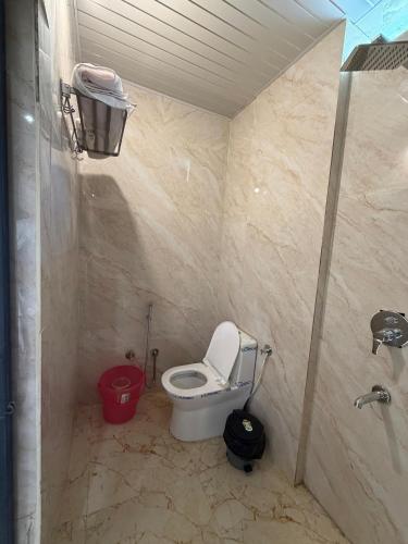 a small bathroom with a toilet and a sink at Hotel Lotus Stay INN in Jabalpur