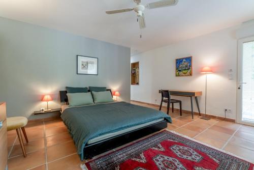 a bedroom with a bed and a table in it at Chambre D'hôtes - Les Hirondelles in Mirabel-aux-Baronnies
