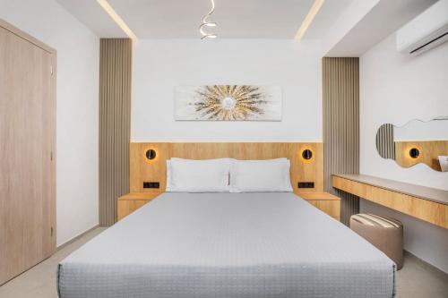 a bedroom with a large bed in a room at Adessa Villas in Afitos