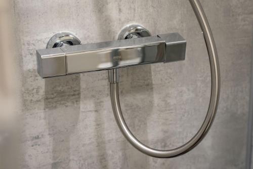 a shower with a shower head in a bathroom at Hazelton Townhouse - Crail in Crail
