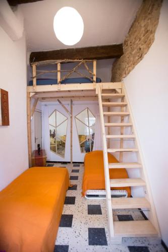 a bedroom with two bunk beds and a staircase at chez nous - la une in Marseillan