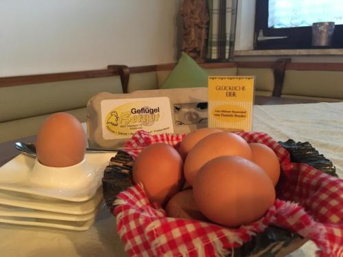 a bunch of eggs in a bowl on a table at Gästehaus Nassfeld in Tröpolach