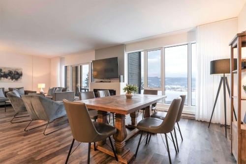 a dining room with a table and chairs at Chic Condo - River View & Comfort with Pool in Baie-Saint-Paul