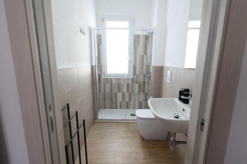 a bathroom with a sink and a toilet and a shower at Ferries apartament in Trapani