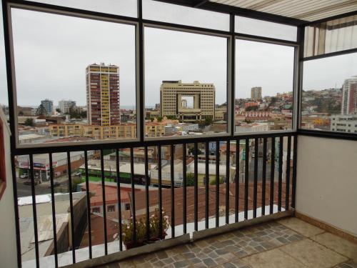 a view of a city from a balcony at Hostal Tunquelen in Valparaíso