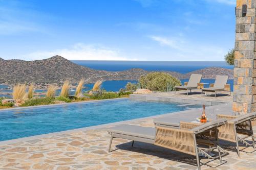 a swimming pool with a view of the ocean at Sole Mare Luxury Villa With Sea View & Private Pool in Elounda in Elounda