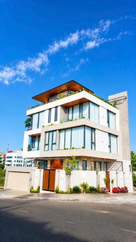 a large white building on the side of a street at Arora Home Pleiku in Pleiku