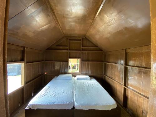 a small room with two beds in it at Lemon Grass Chalets in Kampong Pasir Panjang