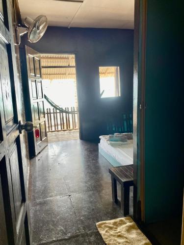 a blue room with a bed and a window at Lemon Grass Chalets in Kampong Pasir Panjang