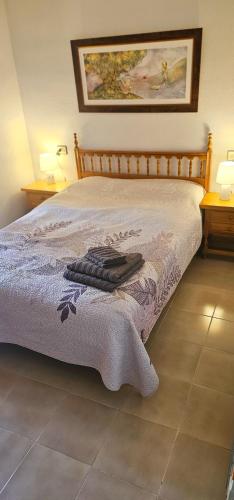 a bedroom with a bed with a blanket on it at Marolesja in Puerto de Mazarrón