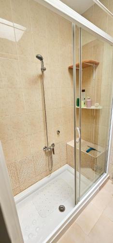 a shower with a glass door in a bathroom at Marolesja in Puerto de Mazarrón