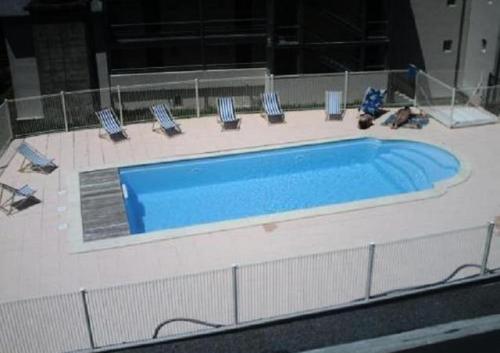 a large swimming pool with chairs on a building at Les Gloriettes in Luz-Saint-Sauveur