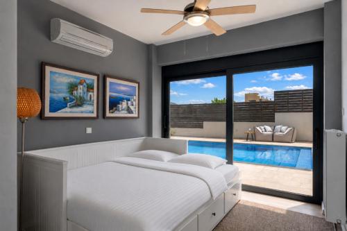 a bedroom with a bed and a swimming pool at Interni Villa by A&D Properties in Porto Rafti