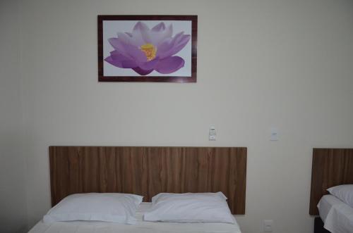 Postel nebo postele na pokoji v ubytování Pousada Recanto Flor de Lótus