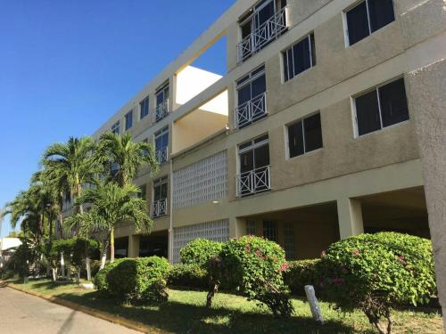 an apartment building with bushes in front of it at Angel's Apartment Jamaica in Kingston