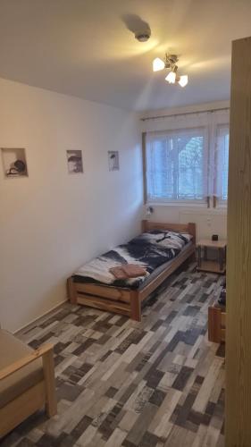 a bedroom with a bed in the corner of a room at Nad Hrází I in Lipno nad Vltavou