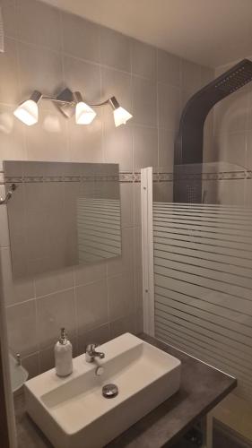a bathroom with a sink and a mirror at Nad Hrází I in Lipno nad Vltavou