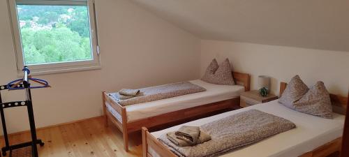a bedroom with two twin beds and a window at Lake House Ceric in Jajce