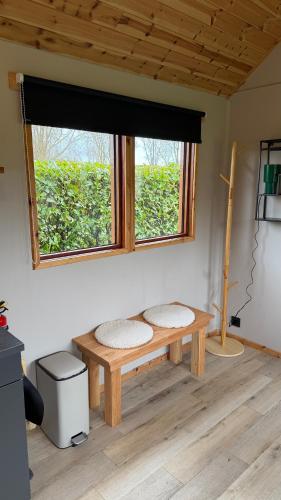 a room with a wooden bench under a window at Tinyhouse Giethoorn in Giethoorn