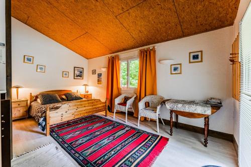 a bedroom with a bed and a desk and a table at Le Cabanon Mios in Mios
