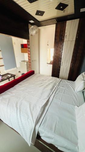 a bedroom with a large white bed in a room at The Comfort stays gomti nagar in Lucknow