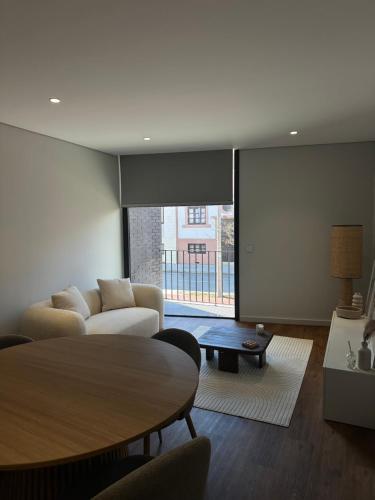a living room with a couch and a table at Premium T1 - Sea & Coast in Espinho