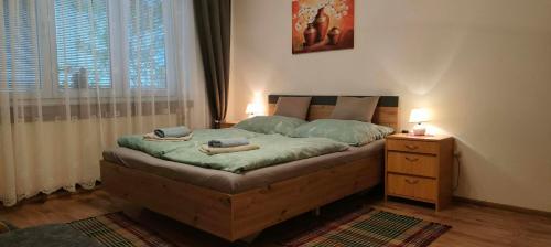 a bedroom with a bed and a nightstand with two candles at Privát Sisi in Hrabušice
