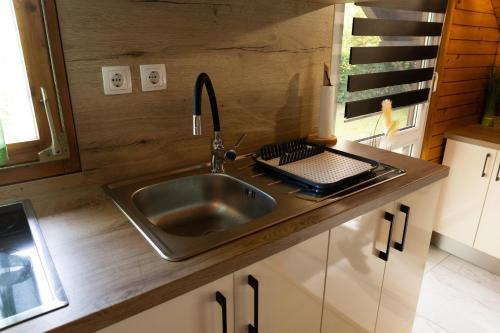 a kitchen with a sink and a counter at Apartma Dobnik in Mozirje