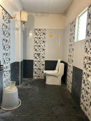 a bathroom with a toilet and a sink at Srilakshmi Residency in Tirupati