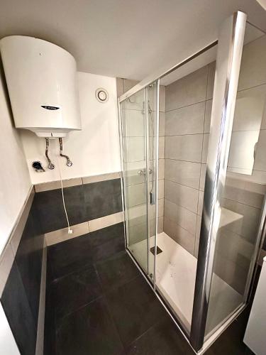 a bathroom with a shower and a glass shower stall at Posada Inés in Castro-Urdiales