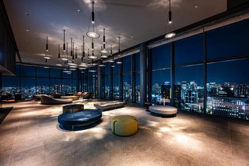 a room with a view of a city at night at The Gate Hotel Osaka by Hulic in Osaka